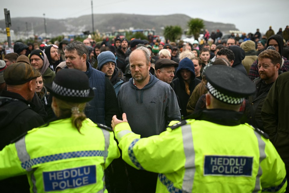 a man in a yellow jacket with the word police on it