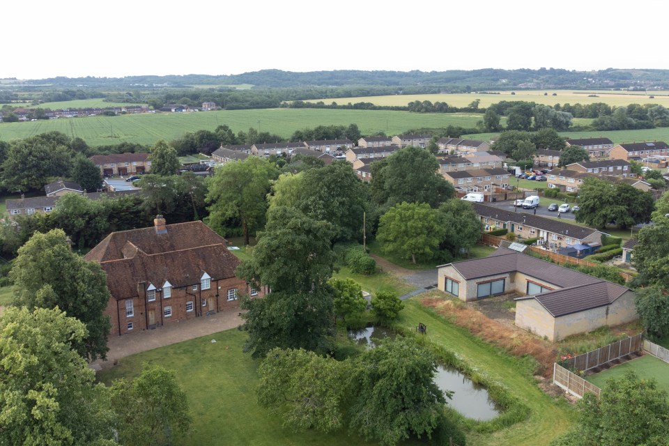 an aerial view of a residential area with houses and trees
