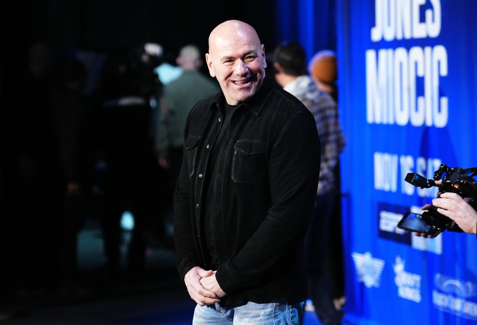 a bald man stands in front of a sign that says june 's mockc