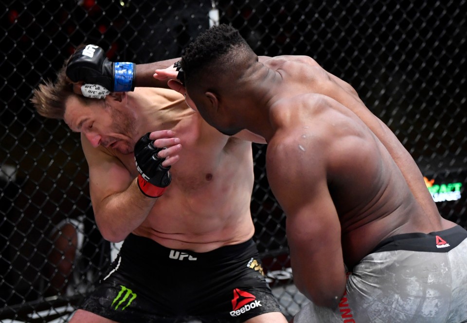 two men in a boxing ring with one wearing reebok shorts