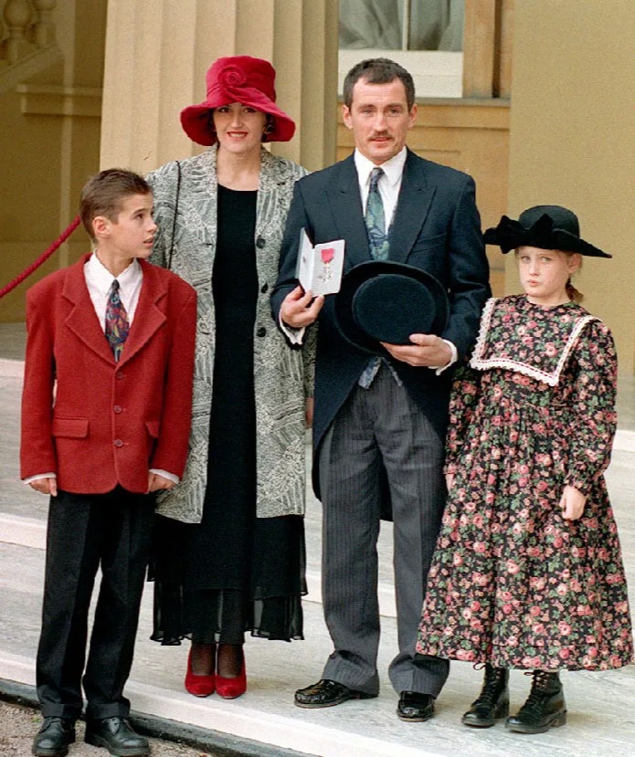 a family posing for a picture with one child wearing a floral dress