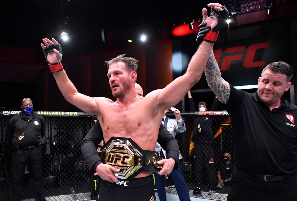 a man with a ufc belt on his waist