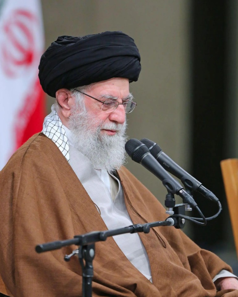 a man with a beard is sitting in front of two microphones