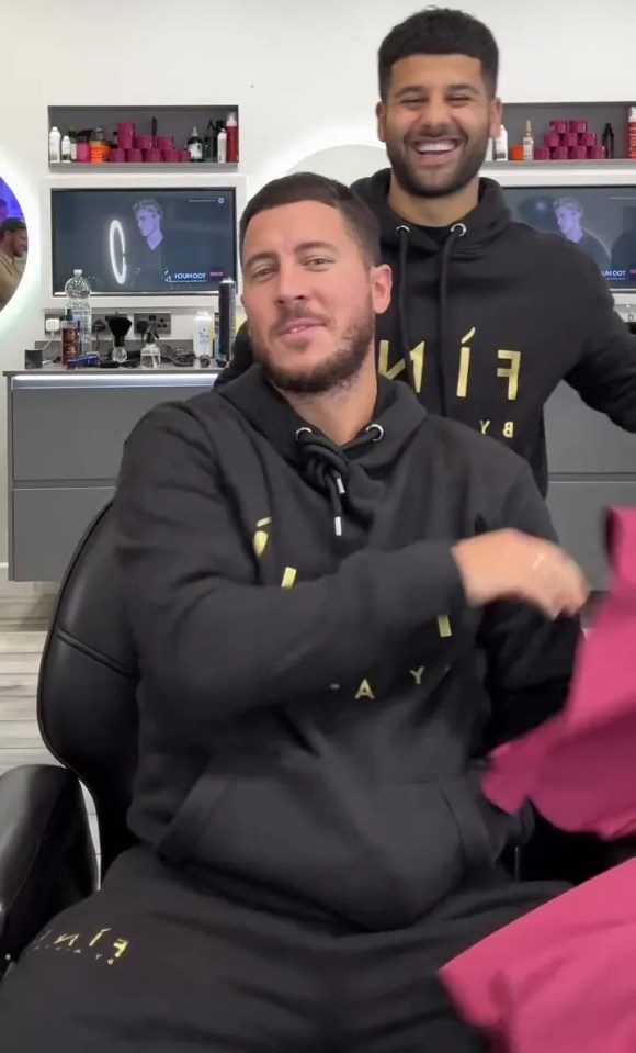a man wearing a black hoodie with the letter a on it