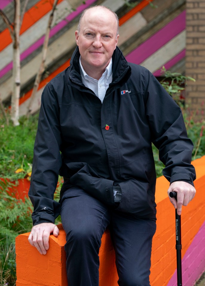 a man wearing a black jacket with the word berghaus on it