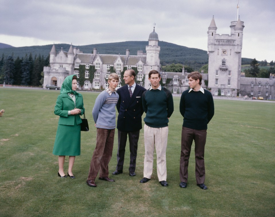 a group of people standing in front of a castle