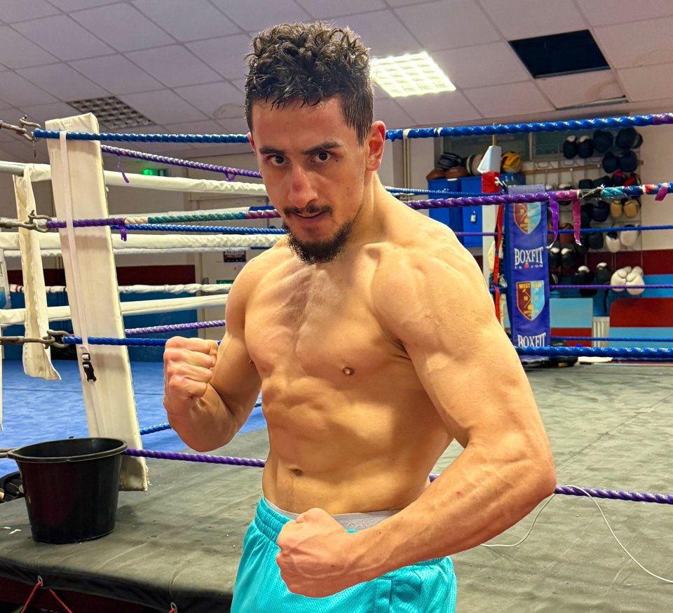 a man in a boxing ring with a sign that says boxfit on it