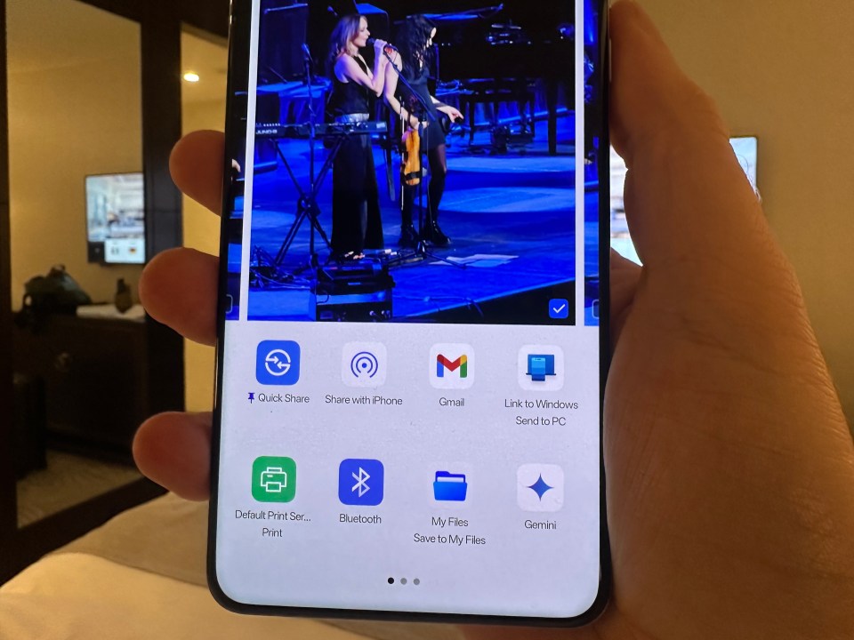 a person is holding a phone with a picture of a woman on the screen