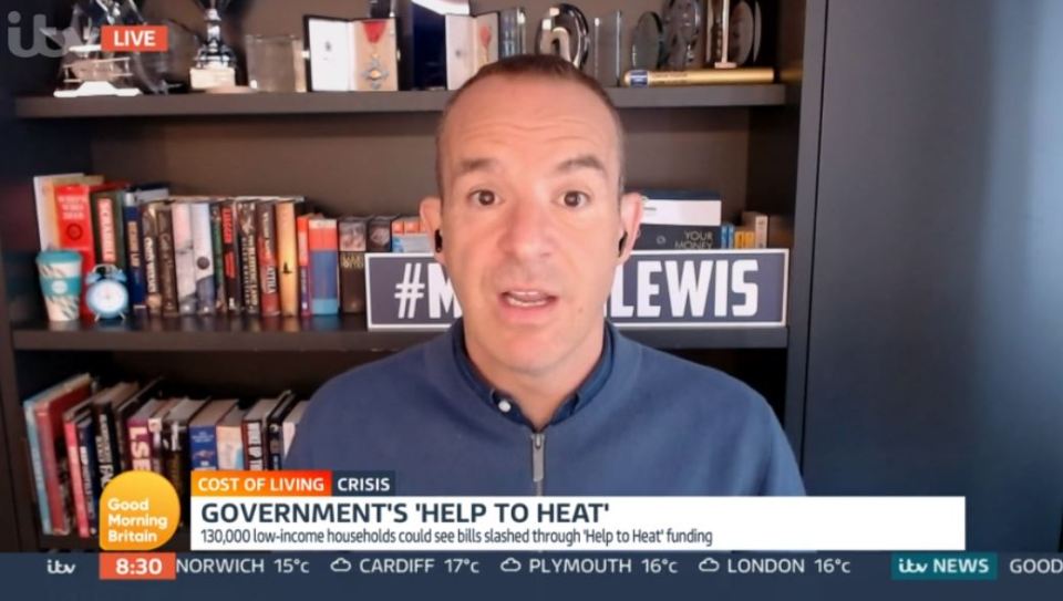 a man in front of a bookshelf with a sign that says #m lewis
