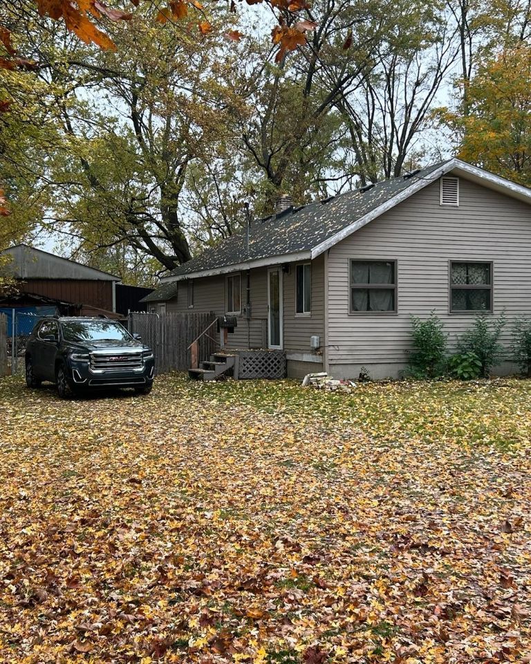 a gmc truck is parked in front of a house