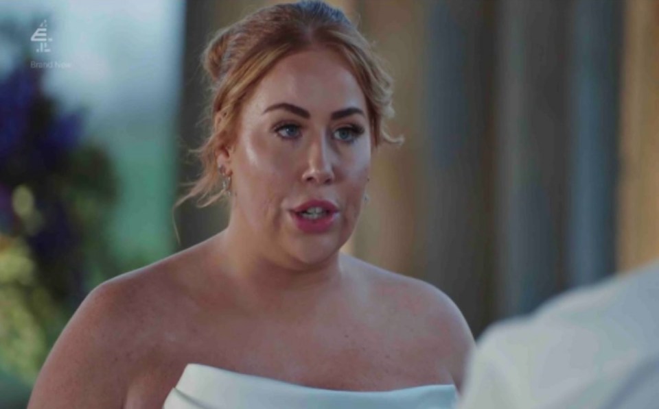 a woman in a wedding dress is talking to a man