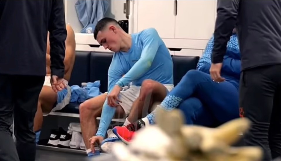 a man in a blue nike shirt sits in a locker room