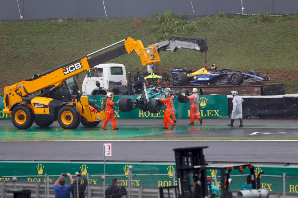 The cars of Aston Martin's Canadian driver Lance Stroll (front) and Williams' Argentine driver Franco Colapinto are removed from the track after their accidents during the qualifying session for the Formula One Sao Paulo Grand Prix, at the Jose Carlos Pace racetrack, aka Interlagos, in Sao Paulo, Brazil, on November 3, 2024. (Photo by Miguel Schincariol / AFP) (Photo by MIGUEL SCHINCARIOL/AFP via Getty Images)