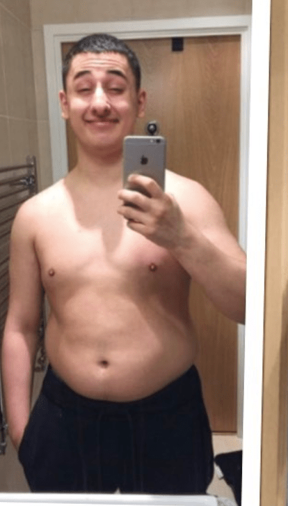 a shirtless man is taking a selfie with an iphone