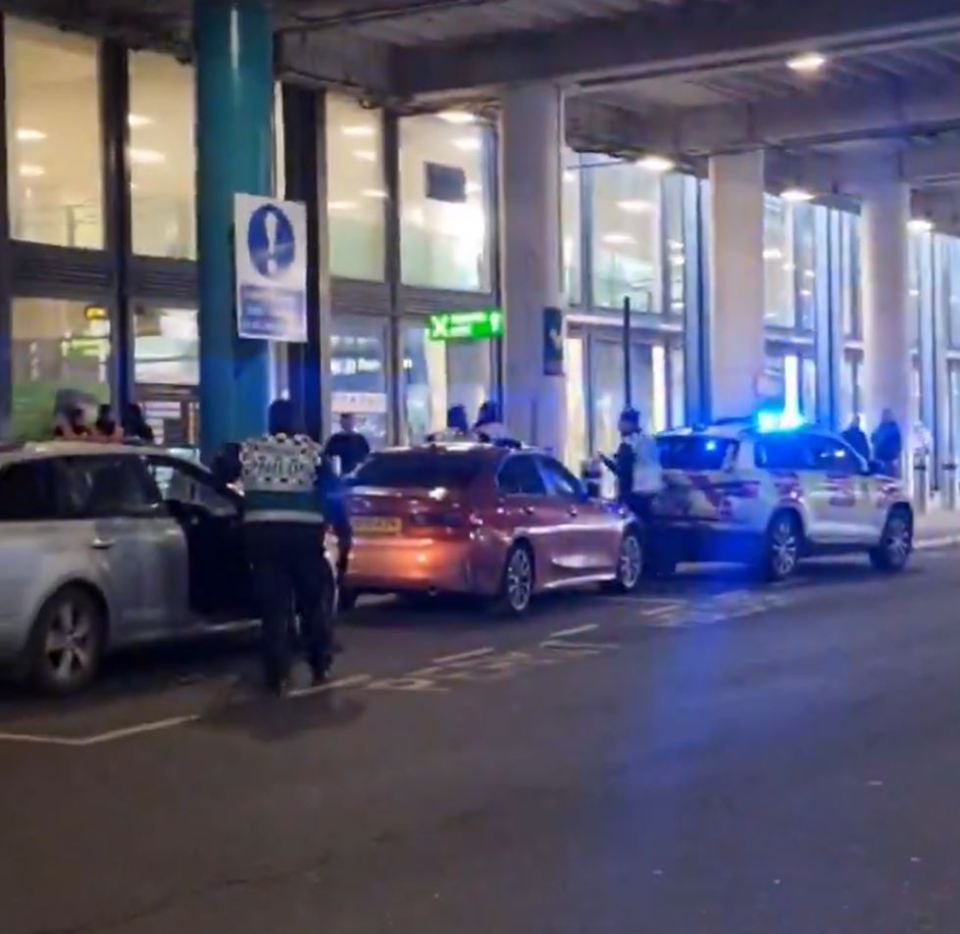a group of cars are parked on the side of the road in front of a building .