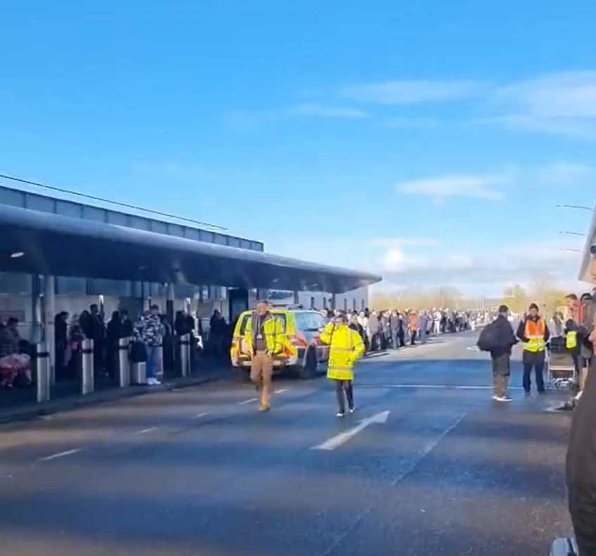 a man in a yellow vest is running towards a yellow van