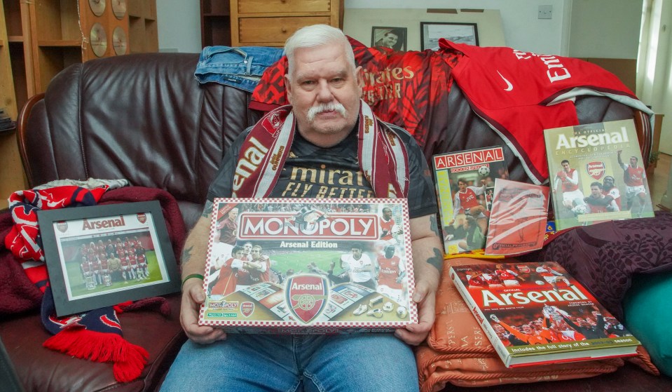 a man sitting on a couch holding a monopoly board game