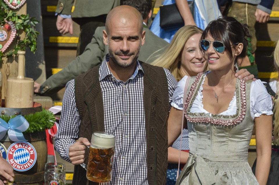 Pep Guardiola and his wife in traditional Bavarian dress at Oktoberfest.