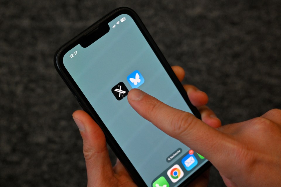 a person holding a cell phone with a x on the screen