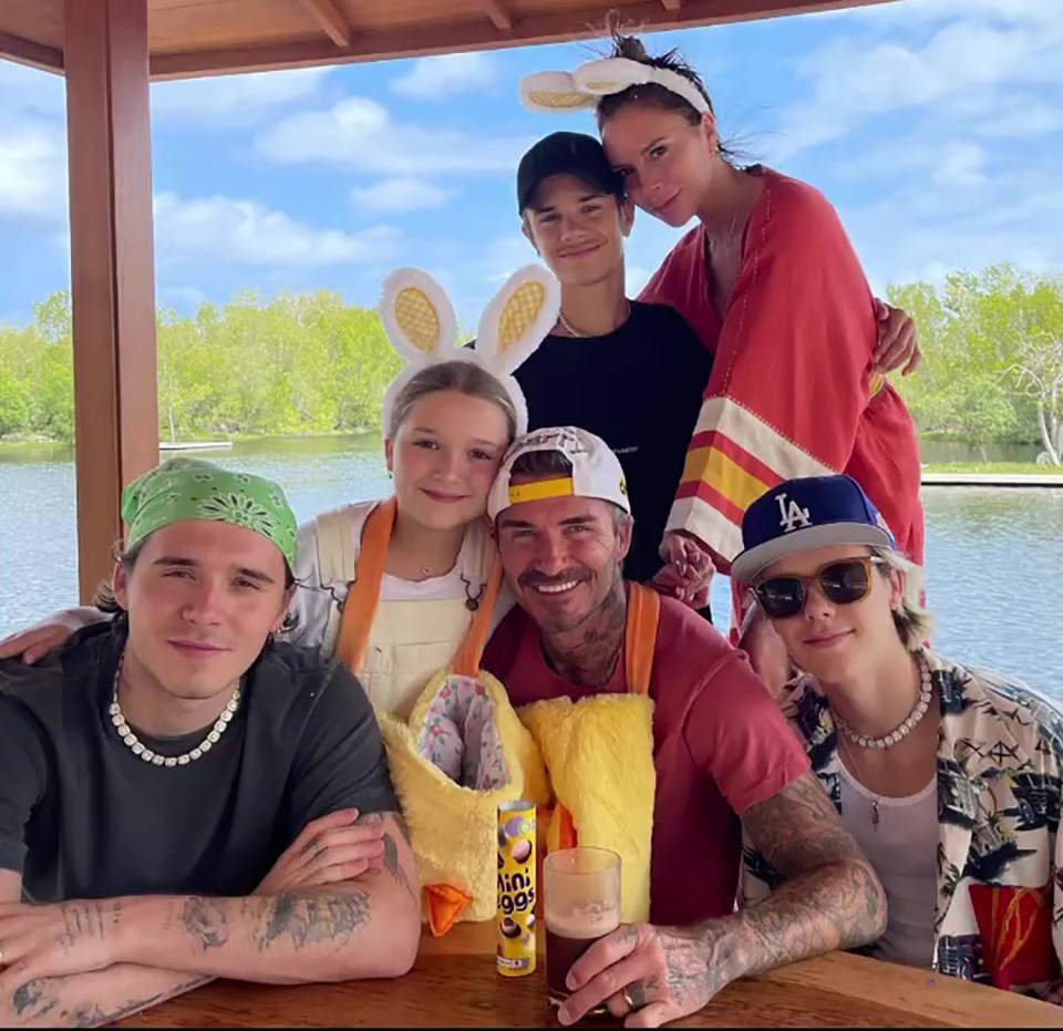 a group of people posing for a picture with one wearing a la hat