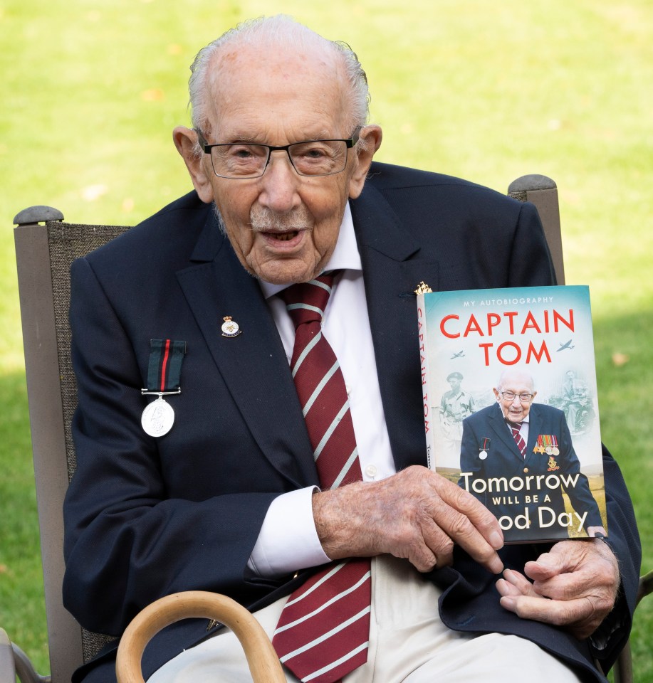 a man in a suit and tie is holding a book called captain tom