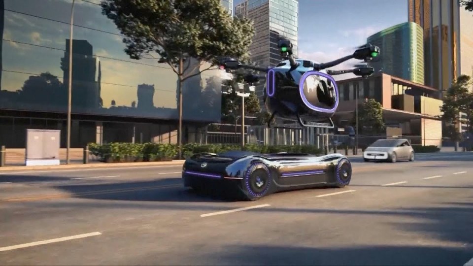 a futuristic vehicle is driving down a city street