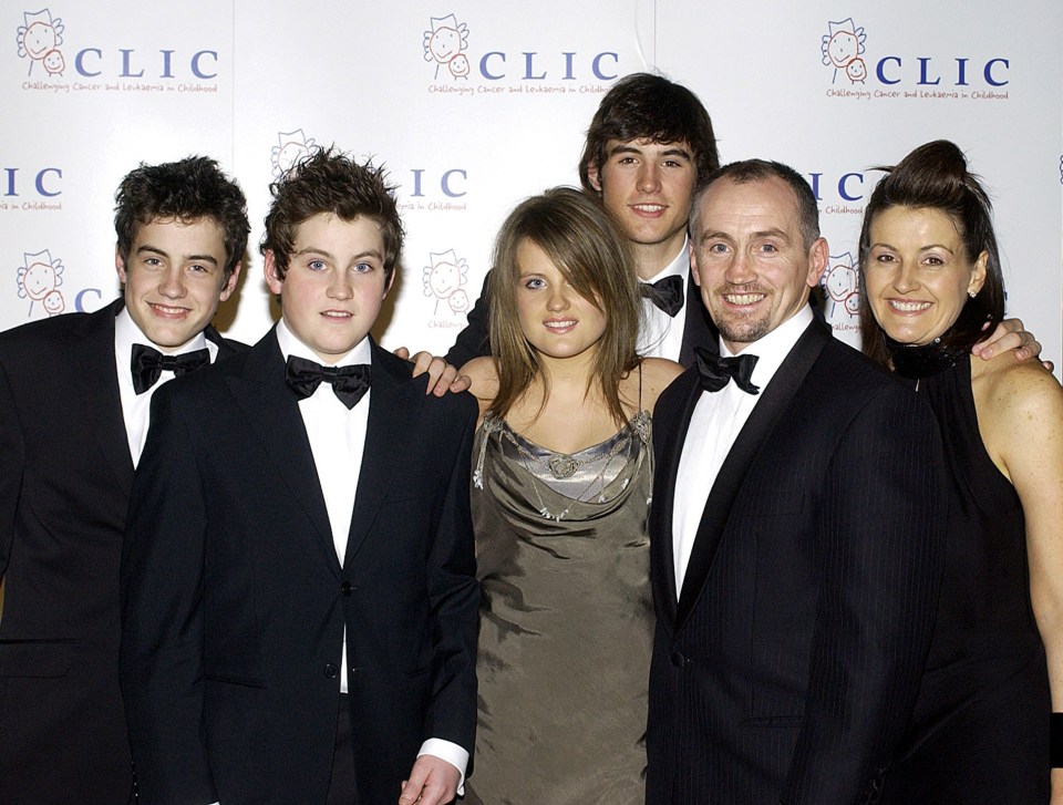 a group of people posing in front of a wall that says clic