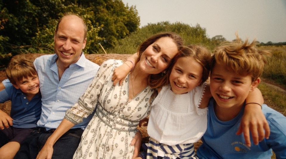 a family posing for a picture with a boy wearing a shirt that says ' i love you ' on it