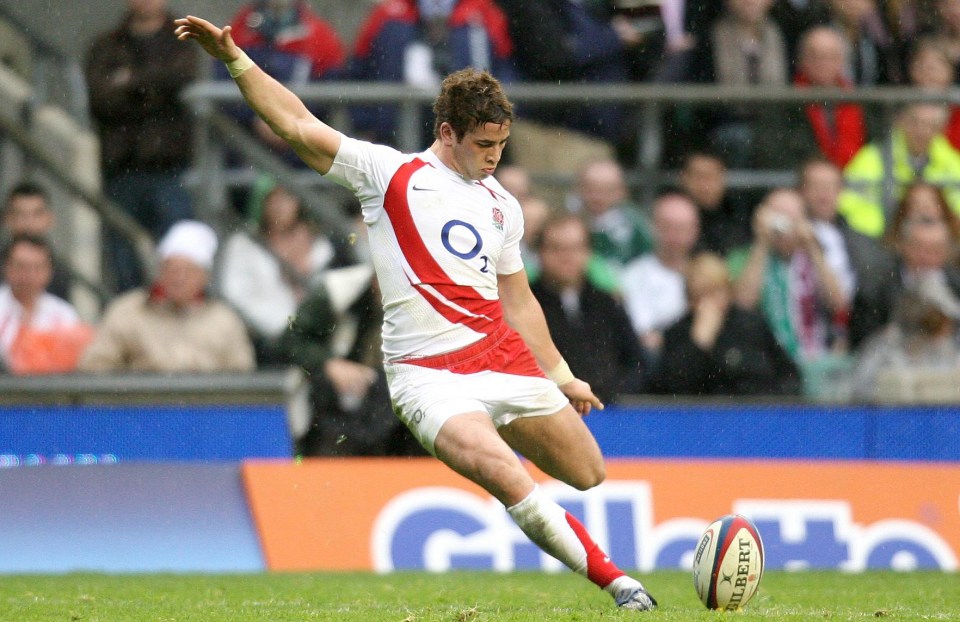 a man kicking a rugby ball with a gillette ad in the background