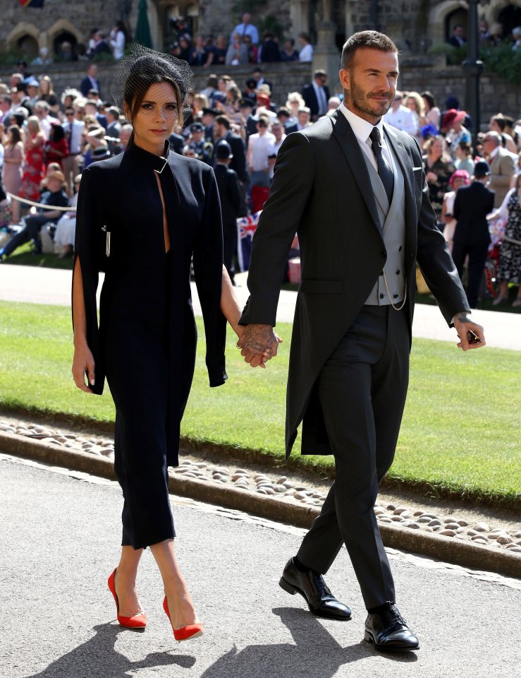 a man and a woman are walking down the street holding hands