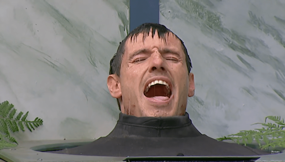 a man in a wet suit is screaming with his mouth open
