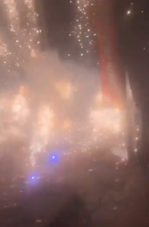 a blurred image of a fireworks display at night .