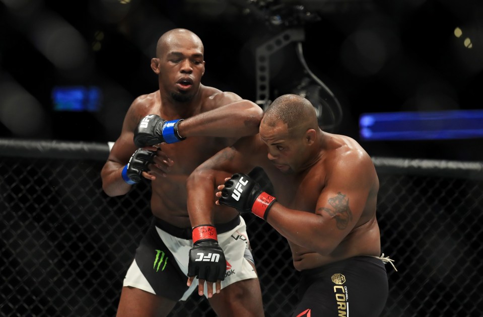 two men in ufc gloves are fighting in a ring