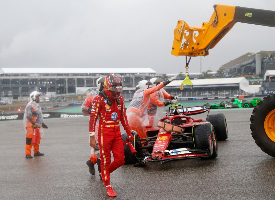 a man in a red suit with the word ferrari on it