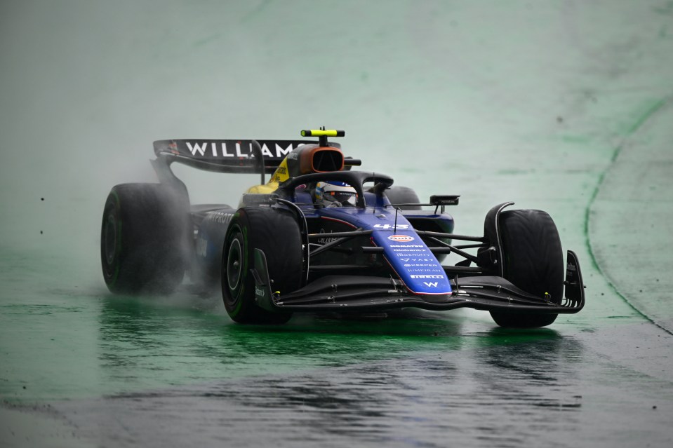 a williams race car is driving on a wet track