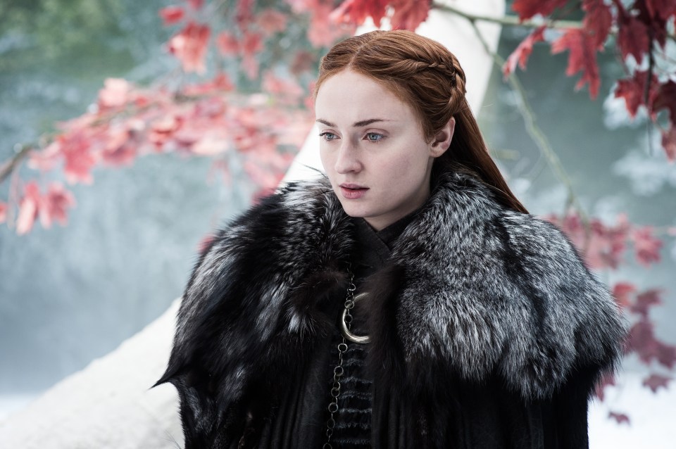 a woman in a fur coat stands in the snow