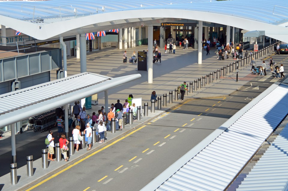 a group of people are waiting at a bus stop at an airport