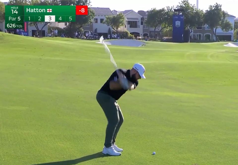 golfer hitting a ball on the 14th hole