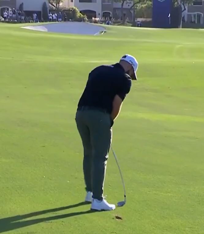 a man is putting a golf ball on a green