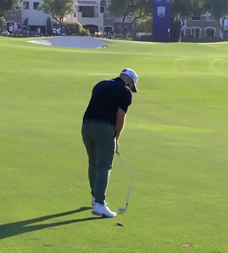 a man in a black shirt and white hat is playing golf