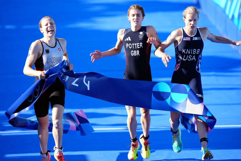three female athletes are crossing the finish line and one of them is wearing a jersey that says potter gbr