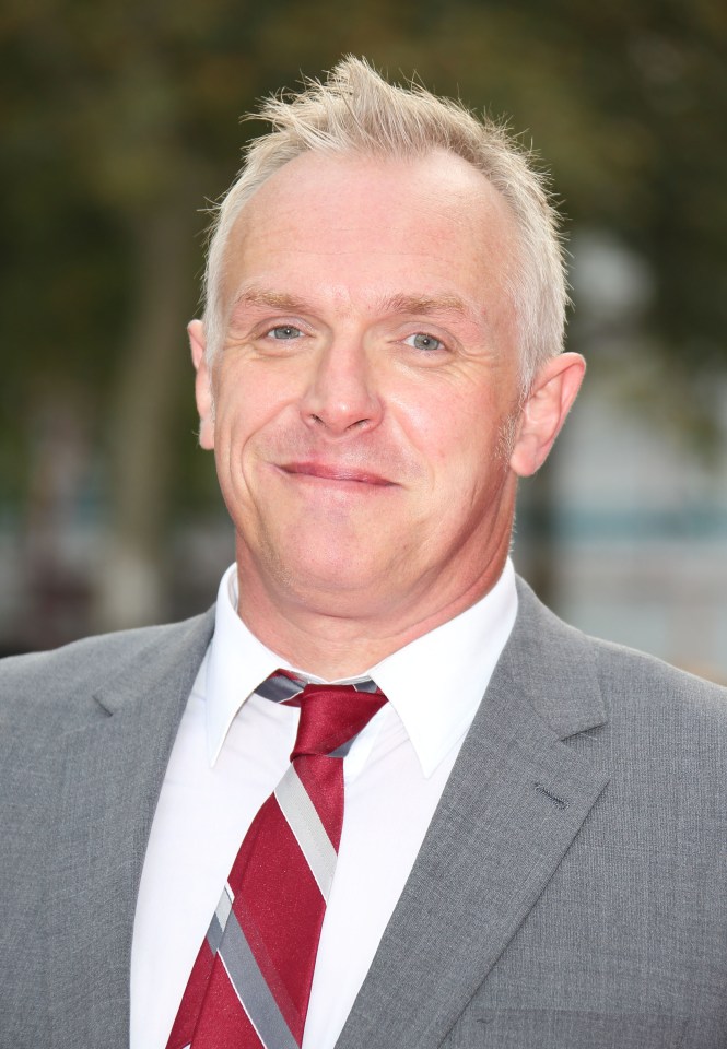 a man in a suit and tie smiles for the camera