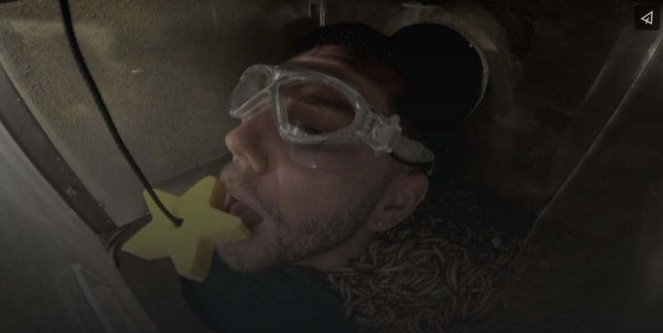 a man wearing goggles and a yellow star in his mouth