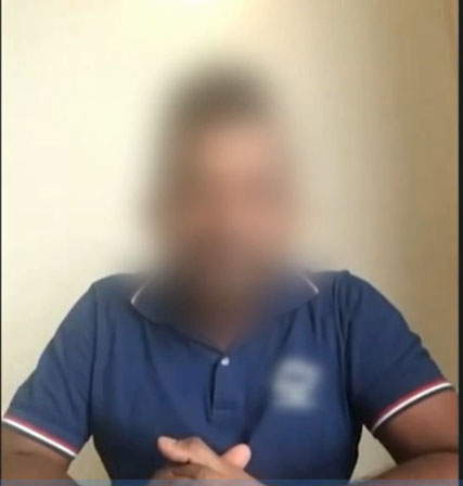 a blurry picture of a man wearing a blue polo shirt .