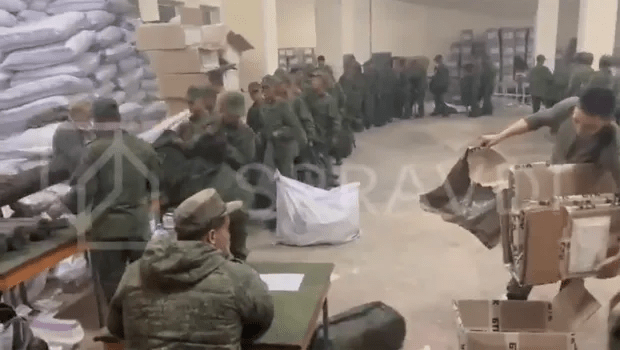 a group of soldiers are standing in a warehouse .