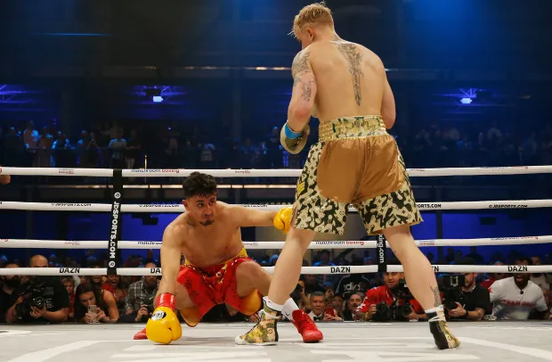 two boxers in a ring with dazn written on the ropes