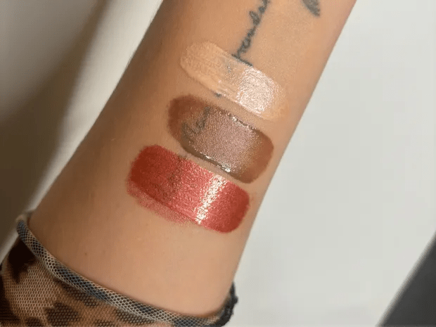 three different shades of lip gloss on a woman 's wrist