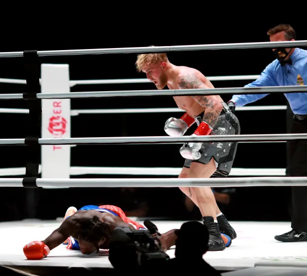 a man in a boxing ring with a twitter logo in the corner