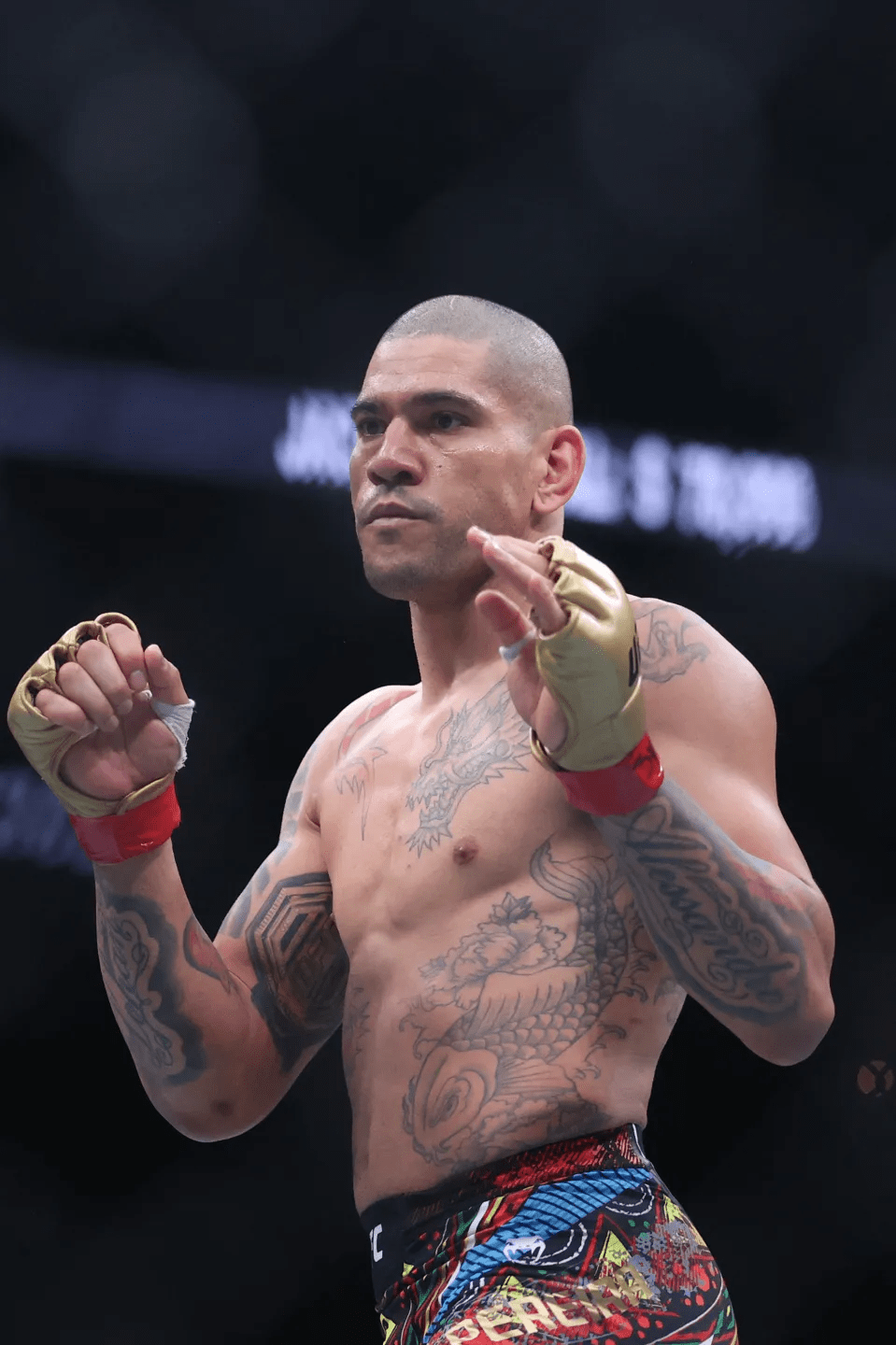 a man with a dragon tattoo on his chest is wearing boxing gloves