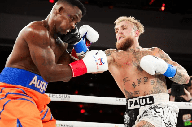 a boxer with paul on his shorts is fighting another boxer